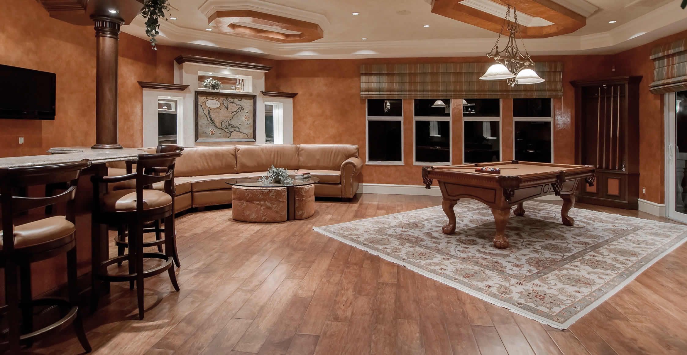 warm toned bar and game room in home