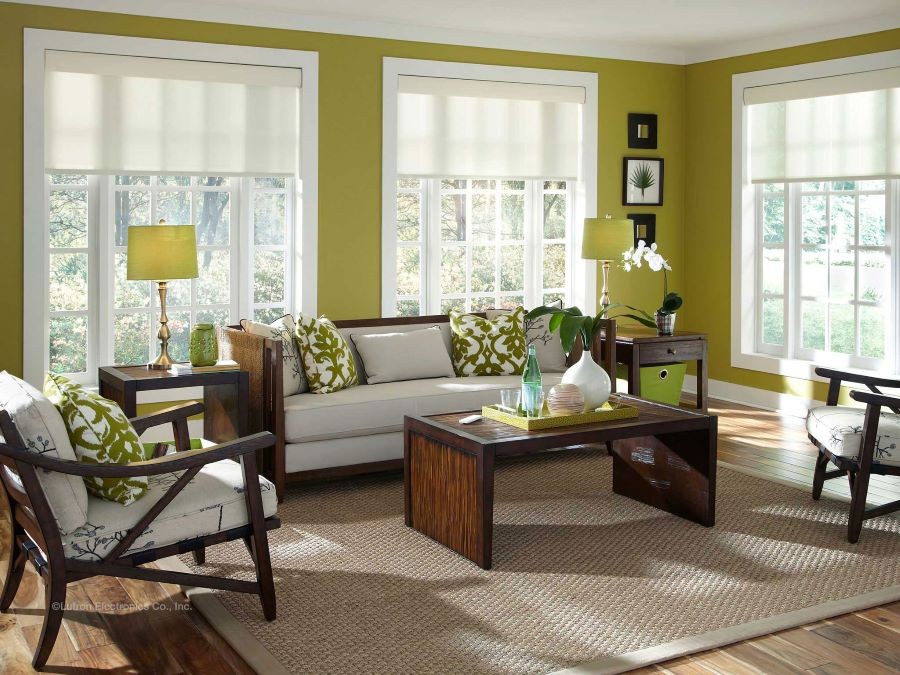 A living room accented in chartreuse with Lutron motorized shades partially lowered over windows.